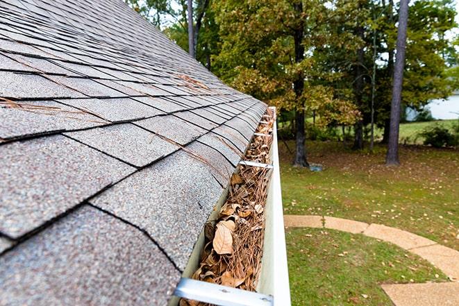 removing leaves and dirt from house gutters